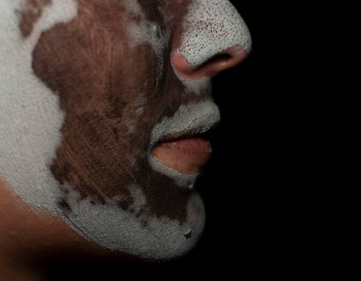 Close-up image of a realistic alien prosthetic applied to an actor's face, showcasing texture and detail.