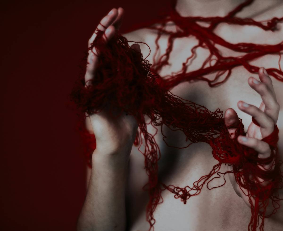 Close-up of prosthetic tools including sculpting spatulas, silicone gel, and brushes.