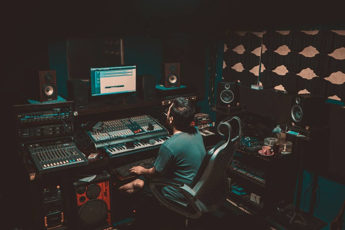 person sitting on chair in front turned-on monitor